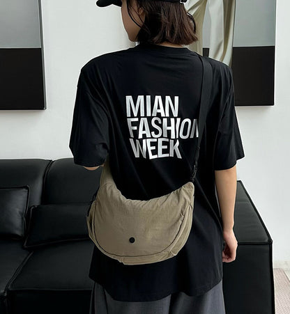 Soft women's sling bag worn across the body for city walks