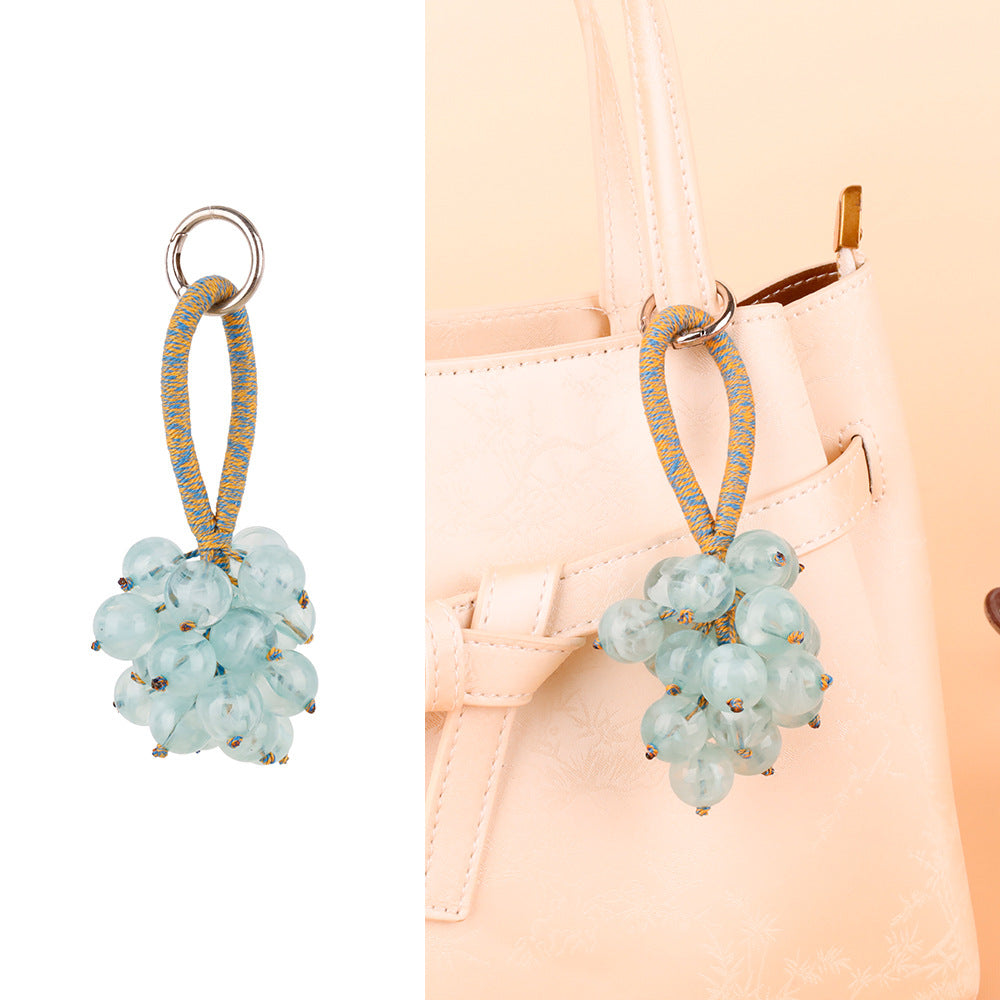 Small jingle bell paired with a fruit-shaped ornament