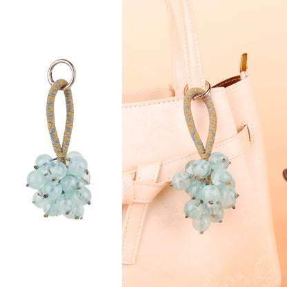 Small jingle bell paired with a fruit-shaped ornament