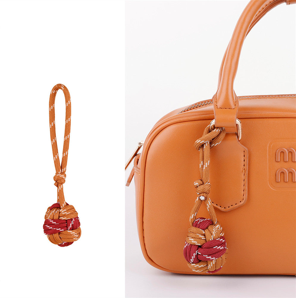 Small woven bag decoration with multicolor cord details