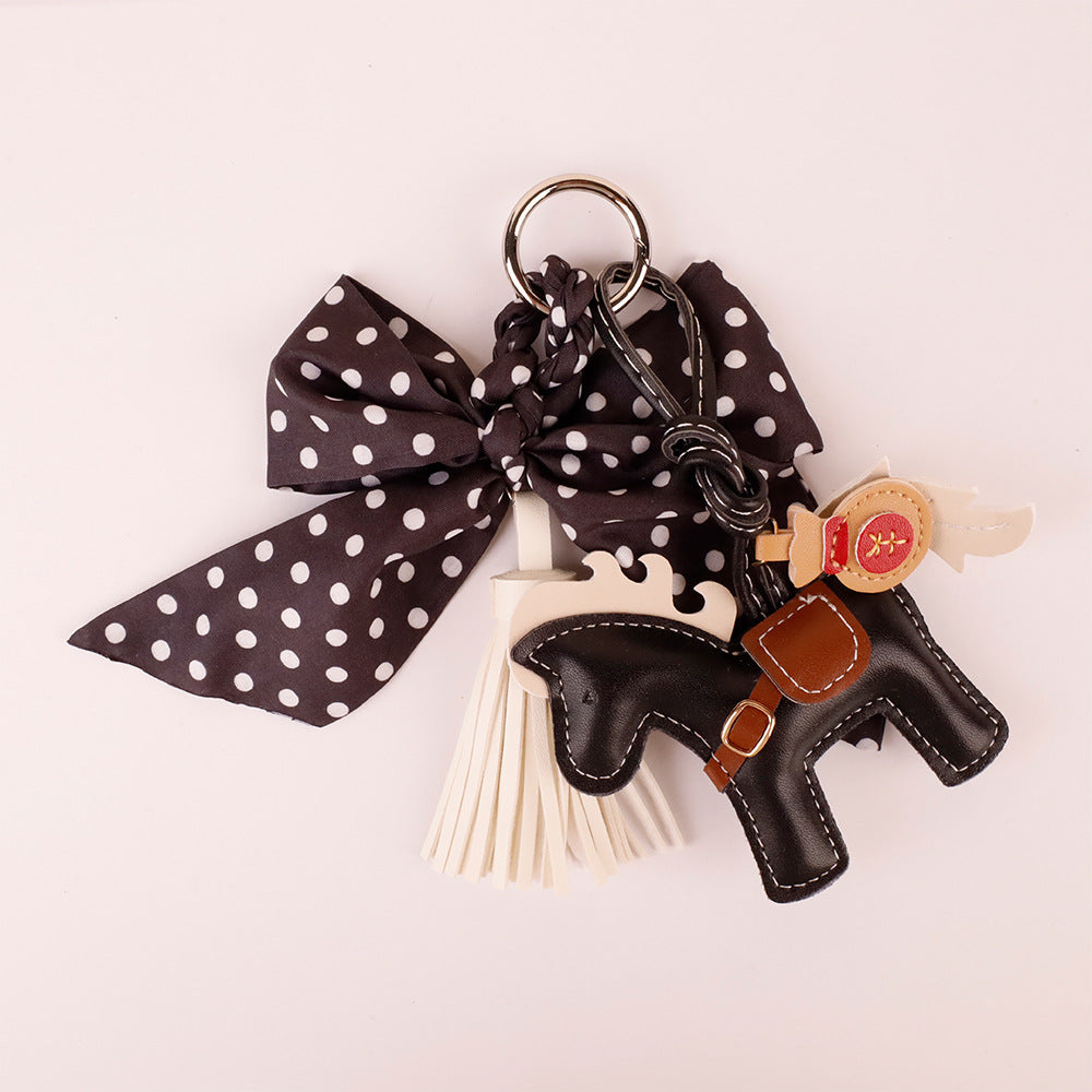 Parisian style bow tie charm styling a beige woven tote bag