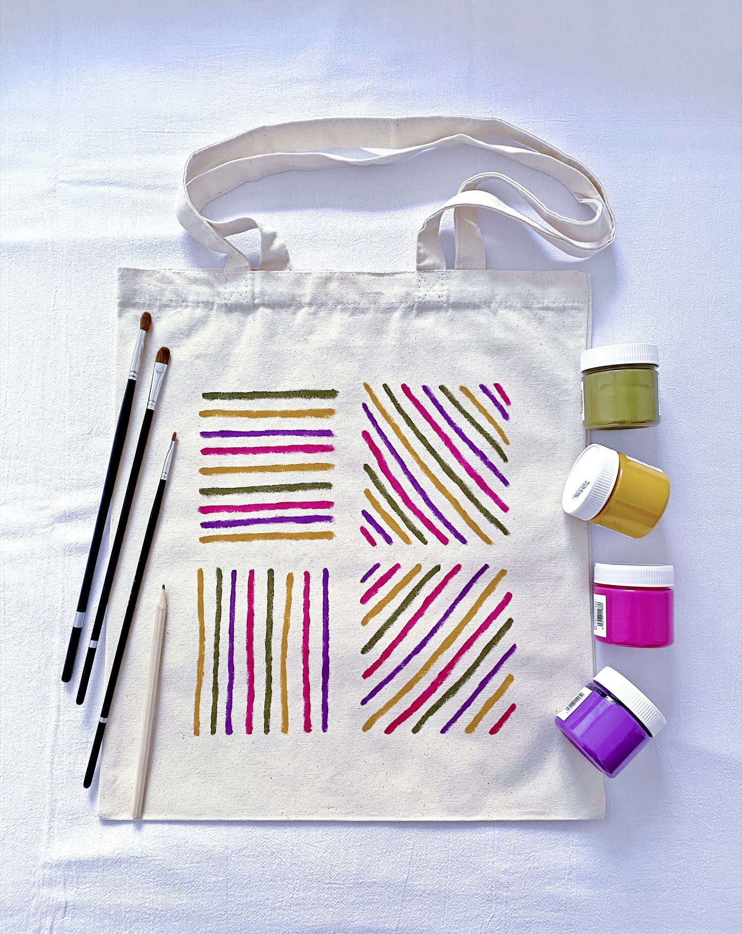 Natural sunlight hitting the hand-painted pattern on a large canvas tote.