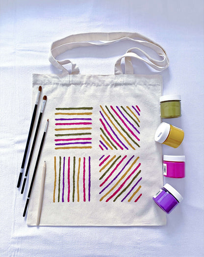 Natural sunlight hitting the hand-painted pattern on a large canvas tote.