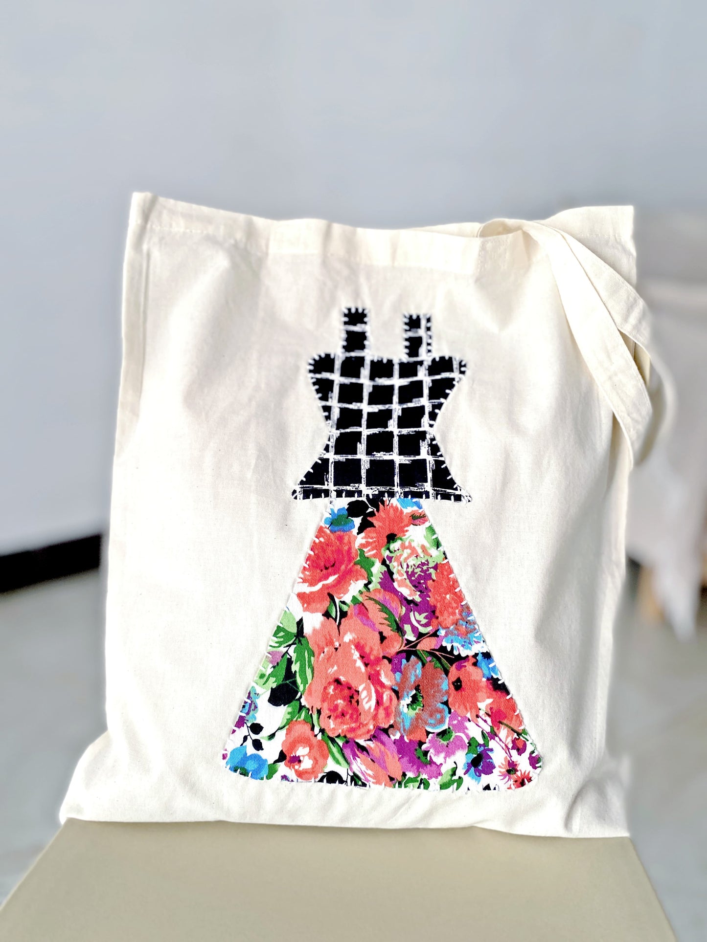 Artisanal cotton tote bag with hand-stitched textile detail.