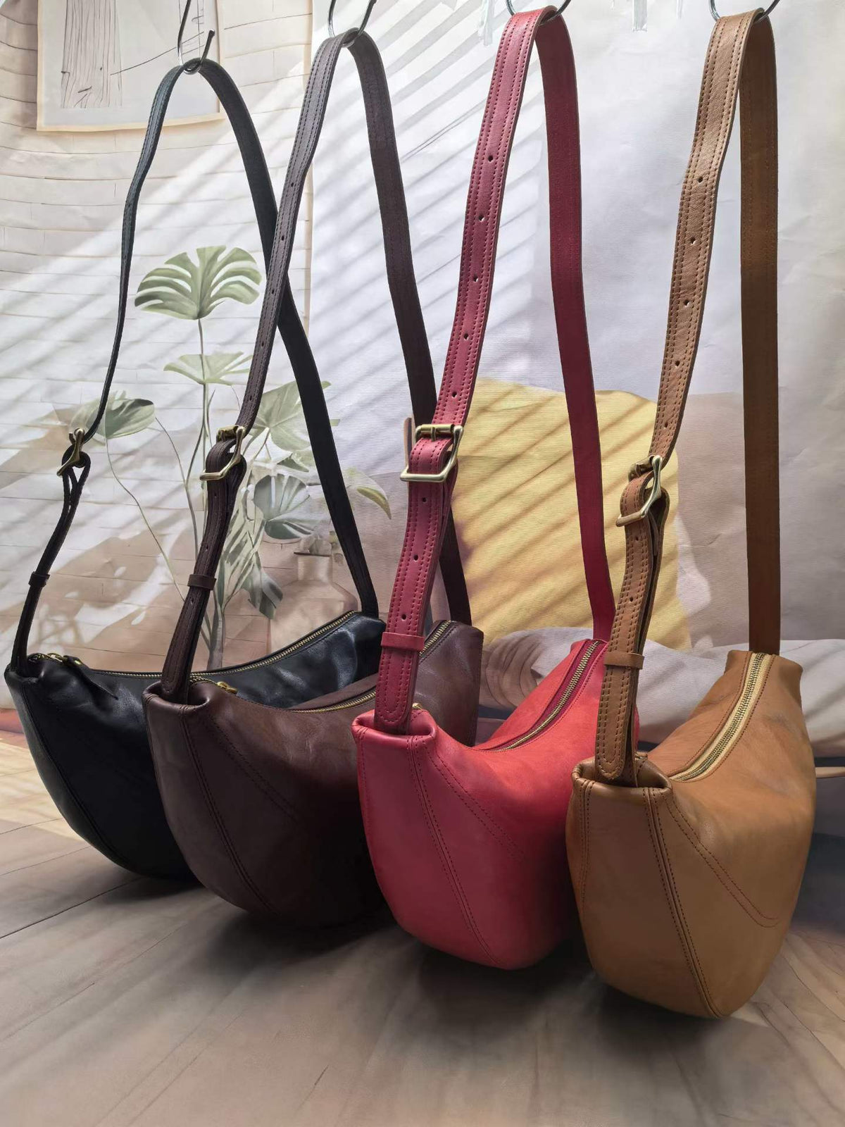 Compact leather sling bag for carrying a phone, wallet, and keys