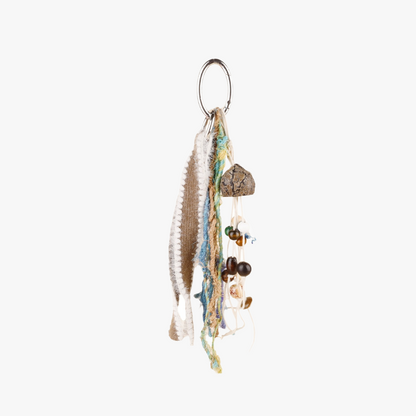 Woven wood bead accessory hanging from a tote bag