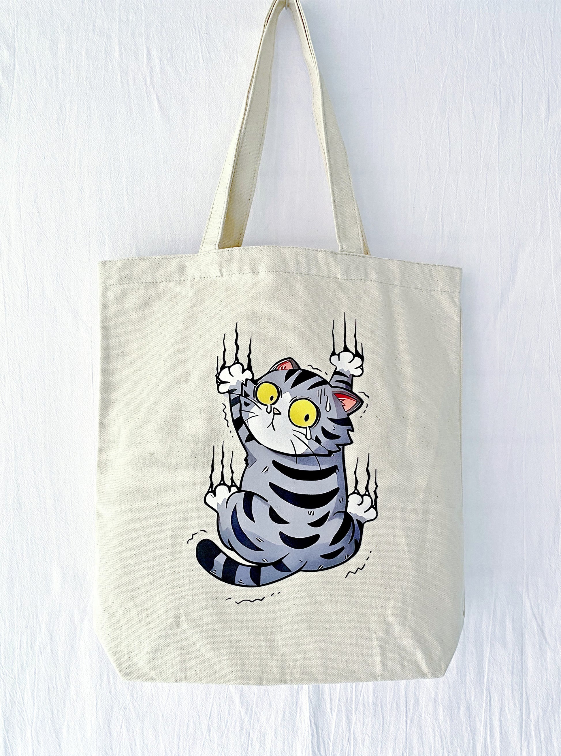 canvas tote bag with hand-printed scared cat illustration