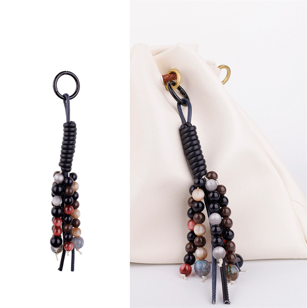 Stylish daily carry leather handbag enhanced with a handmade beaded tassel charm
