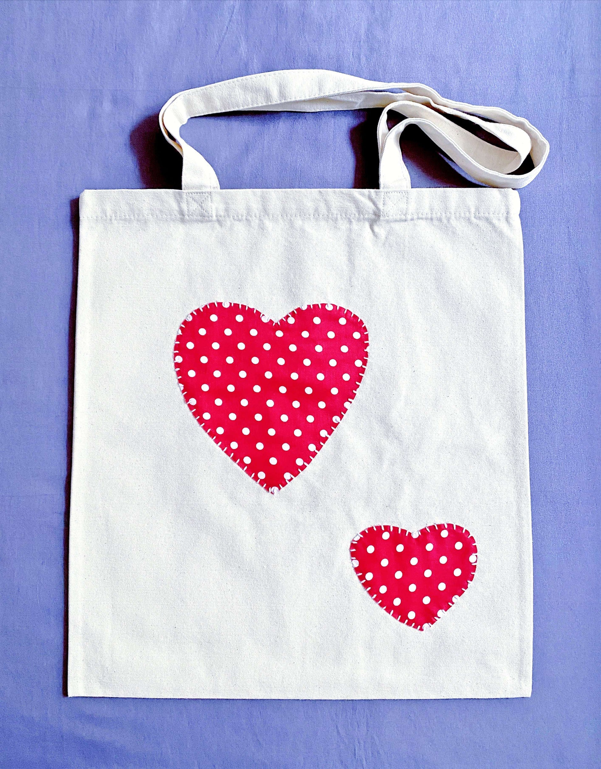 The textured feel of organic cotton patchwork hearts designed for those who find comfort in carrying a bag that feels like a piece of art rather than a mass-produced item.