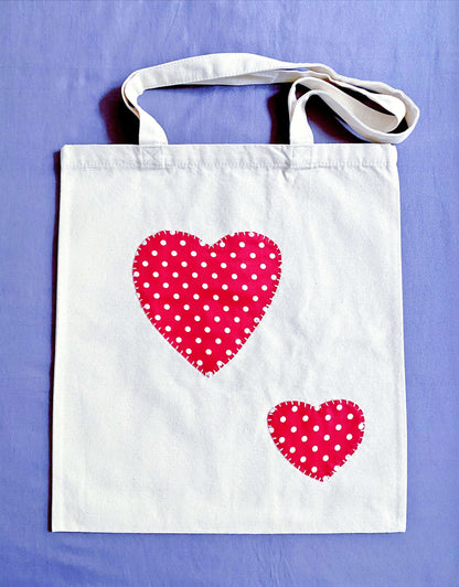 The textured feel of organic cotton patchwork hearts designed for those who find comfort in carrying a bag that feels like a piece of art rather than a mass-produced item.