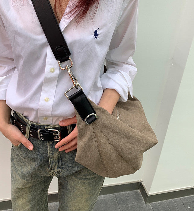 Women's moon-shaped shoulder bag styled for a casual street look