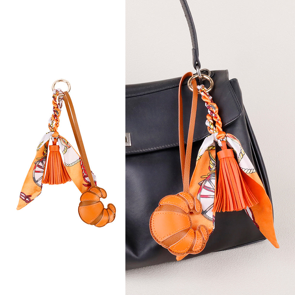 Elegant purse accent featuring a scarf and tassel combination