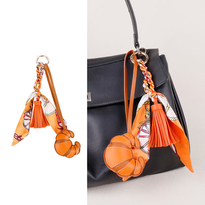Elegant purse accent featuring a scarf and tassel combination