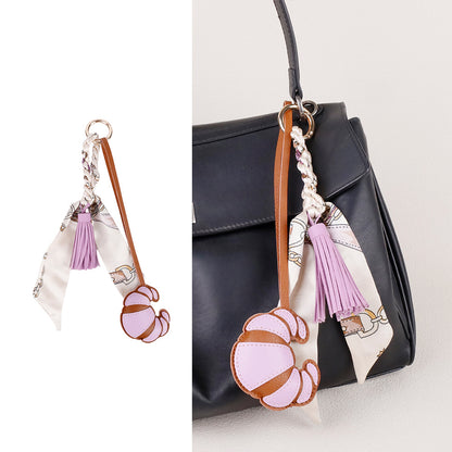 Handmade decorative detail clipped to a women's handbag