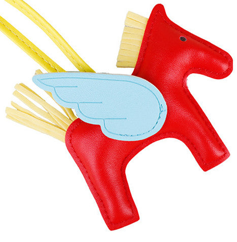 Stylish handbag ornament featuring a horse motif and draped scarf tassel accent