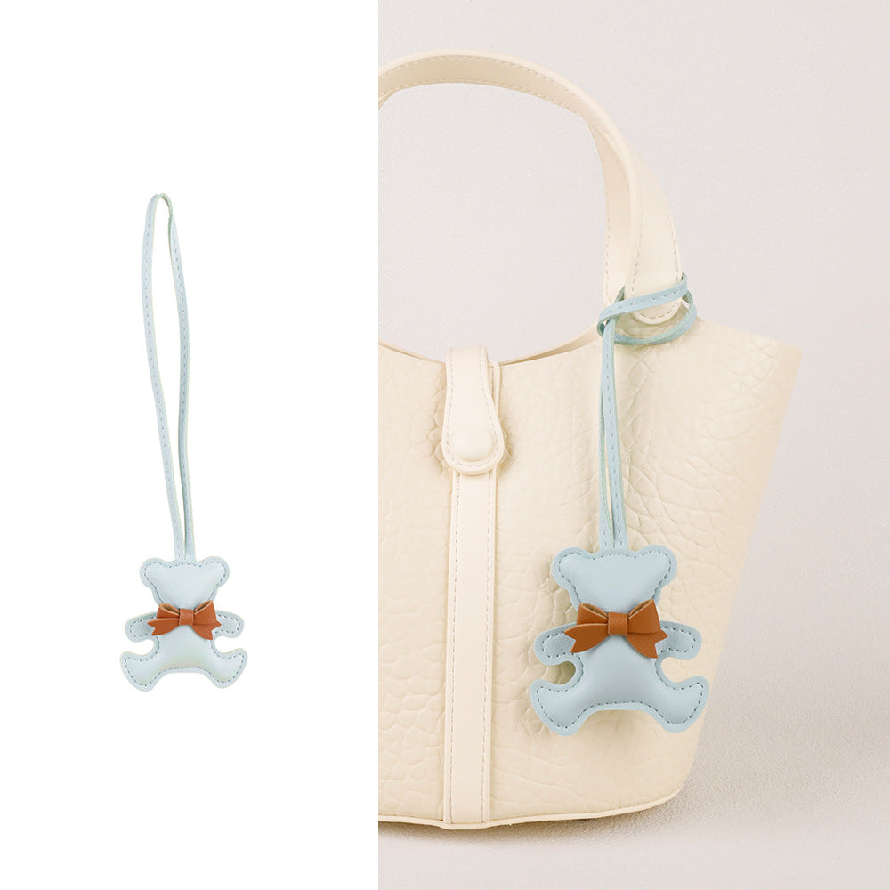 High-end purse accessory featuring a mini bear design and smooth silk tassel
