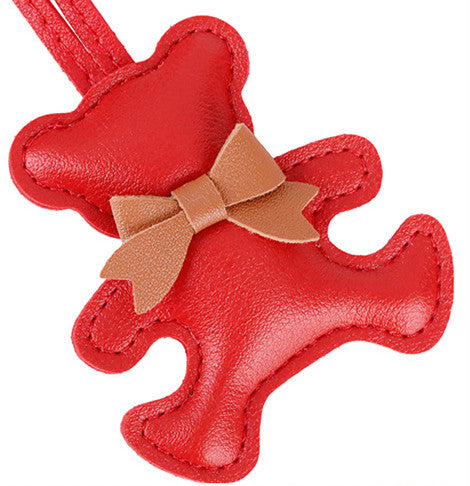 Cute teddy bear bag pendant attached to a classic everyday crossbody purse