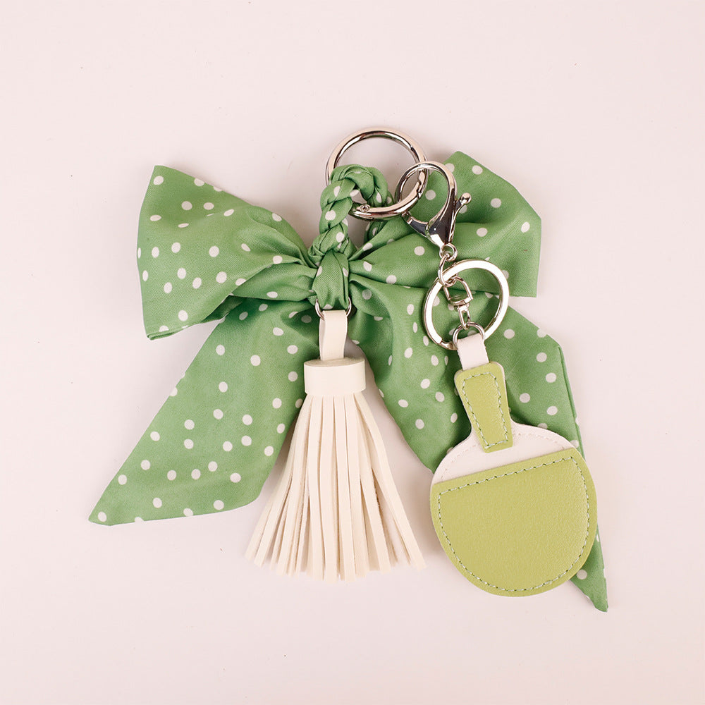 Green scarf ribbon keychain attached to casual travel tote bag