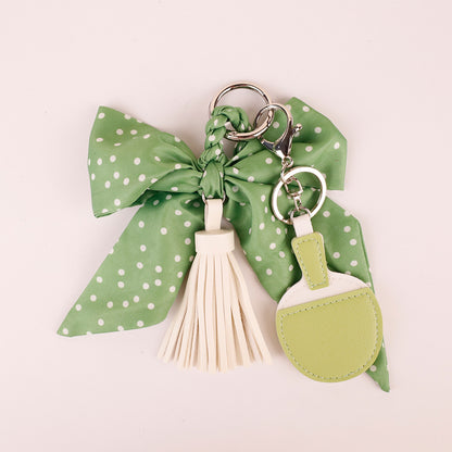 Green scarf ribbon keychain attached to casual travel tote bag