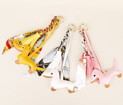 Detailed stitching on a handcrafted sausage dog bag pendant