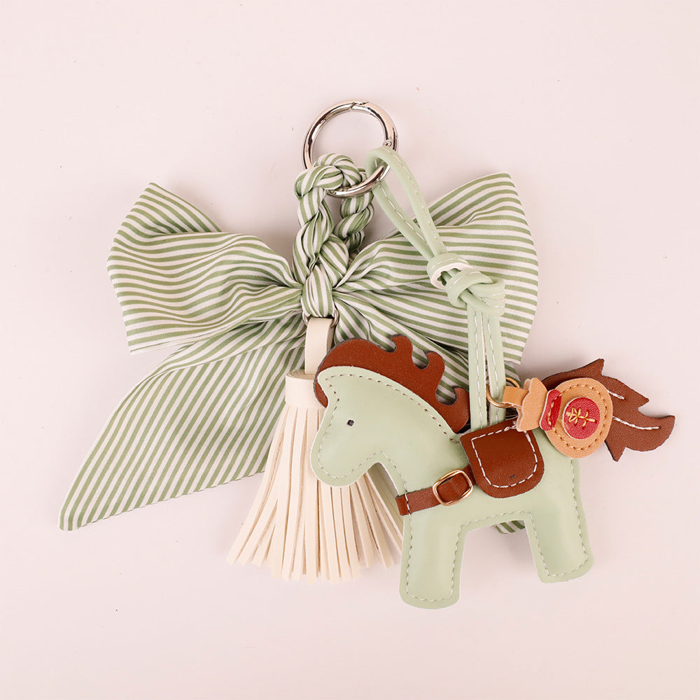 Aesthetic purse charm in forest green tones on a neutral background