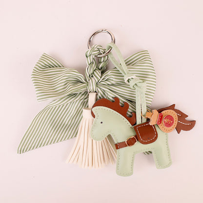 Aesthetic purse charm in forest green tones on a neutral background