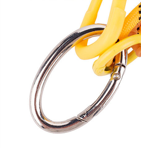 Sporty bag charm in striking yellow tone attached to a black shoulder bag