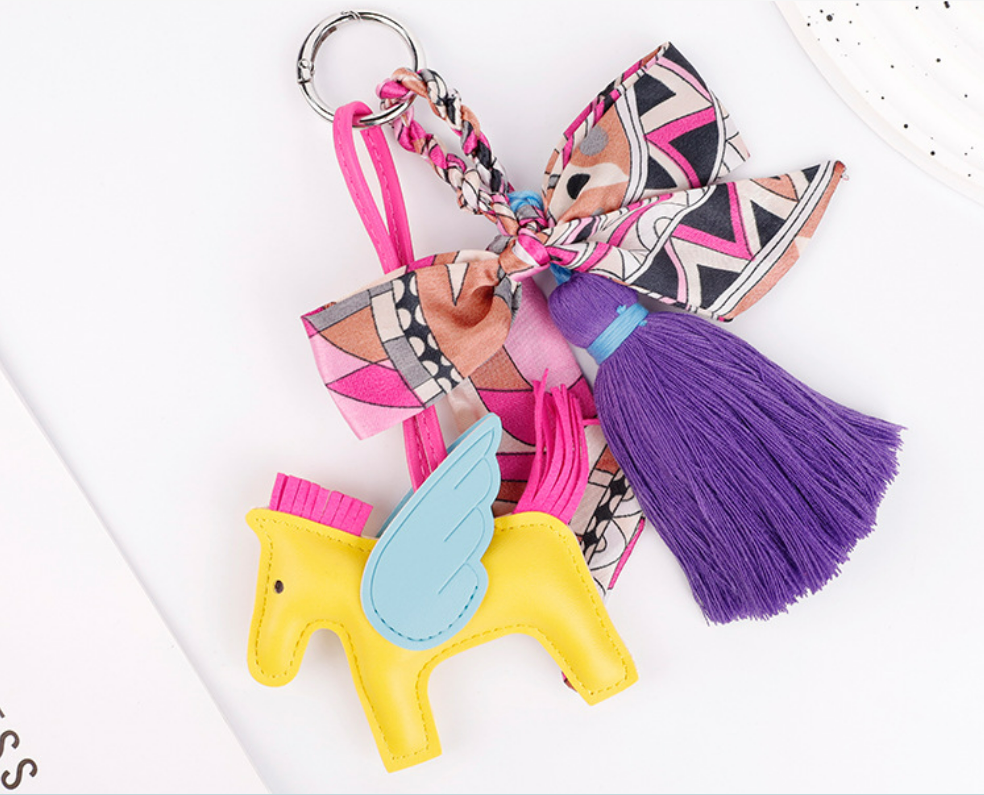 Horse charm hanging from a casual shoulder bag
