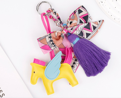 Horse charm hanging from a casual shoulder bag