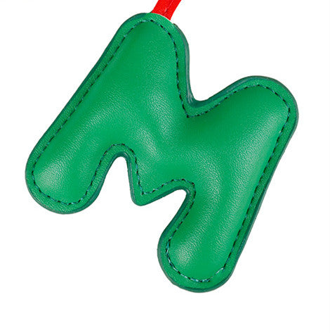 Small heart-shaped plush hanging from a tote