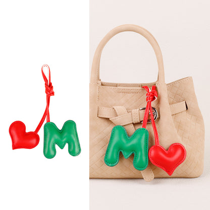 Padded leather heart hanging from a shoulder bag