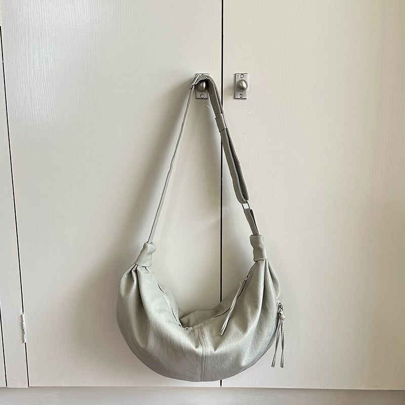 Half-moon sling purse worn for an afternoon outing.
