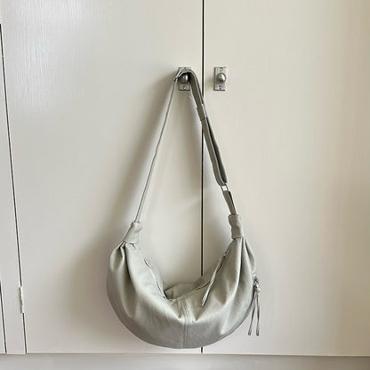 Half-moon sling purse worn for an afternoon outing.