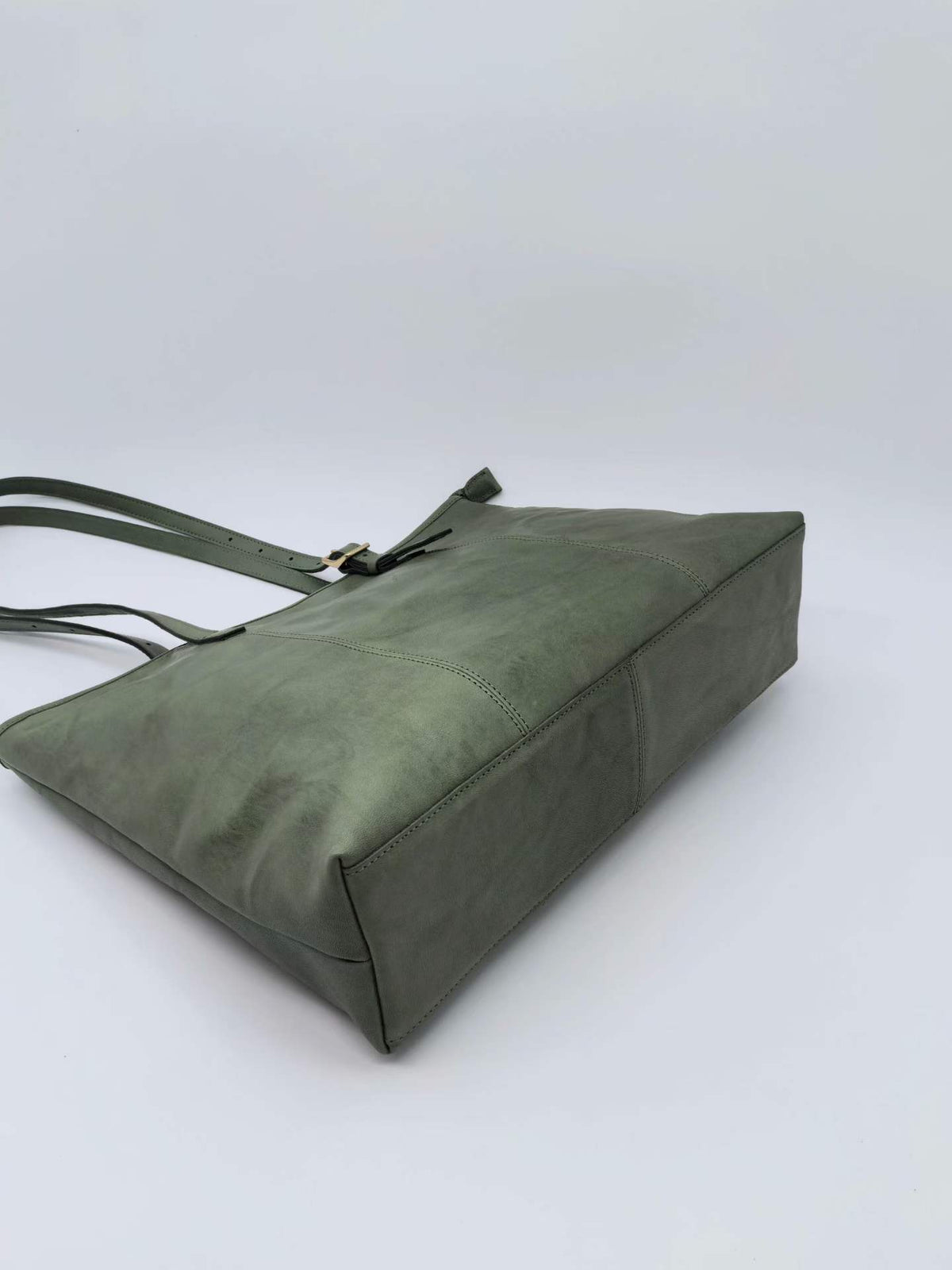 Full-capacity leather tote with interior pockets for keeping everyday belongings organized.