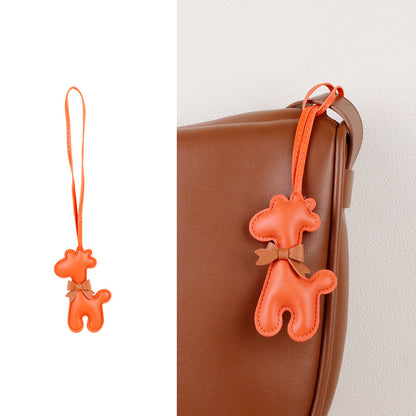 Giraffe keychain accessory displayed beside everyday keys