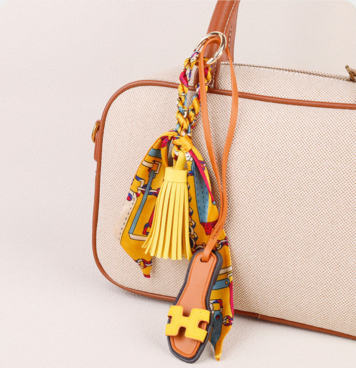 Slipper bag charm styled on an everyday handbag