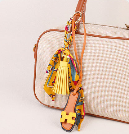 Slipper bag charm styled on an everyday handbag