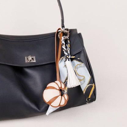 Fashion accessory styled on a neutral everyday tote