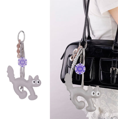 Quirky cat keyring decorating the front of a pastel summer tote bag