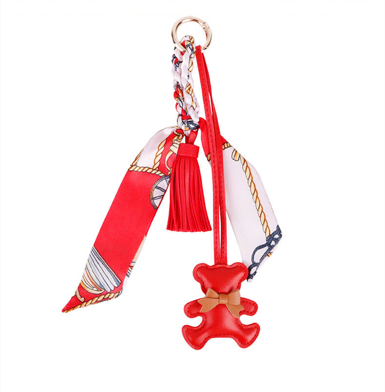 Elegant designer purse clip with a cute bear and flowy tassel detail