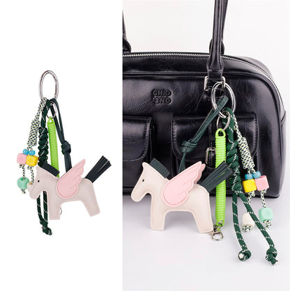 Horse purse accent with braided string loop on a tote