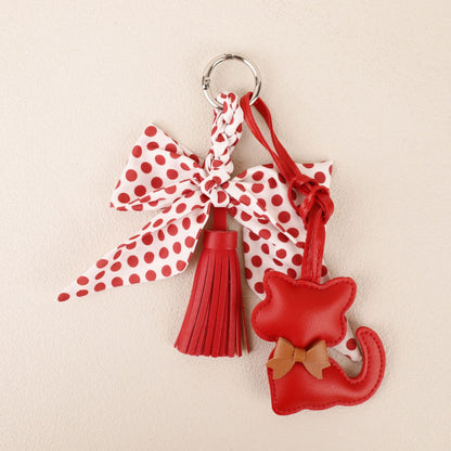 Red scarf-inspired bow charm for decorating a leather handbag