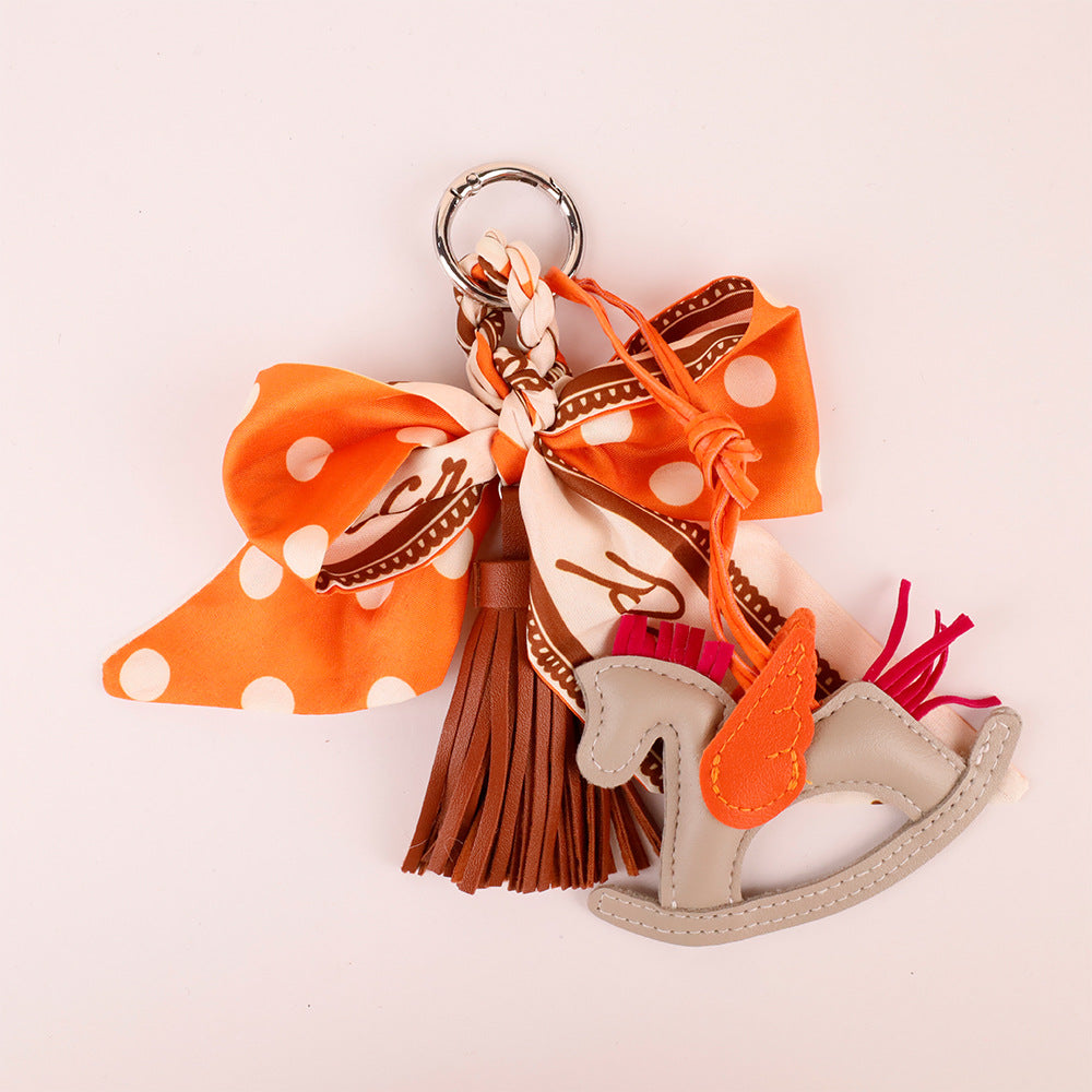 Soft orange scarf bow charm with decorative tassel