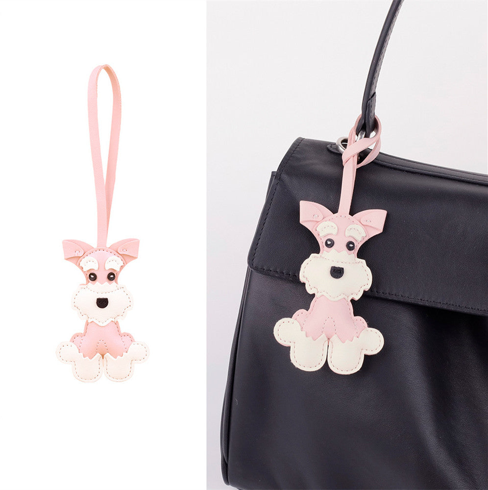 Cartoon puppy hanging from a canvas tote handle
