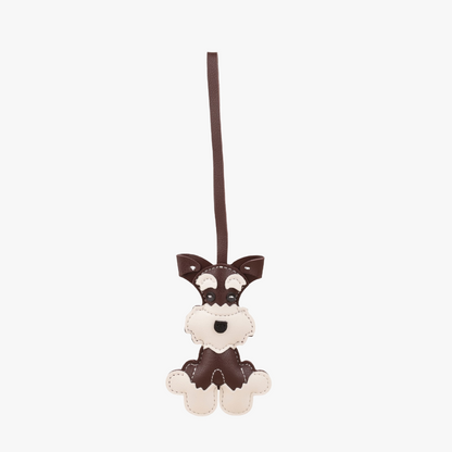 Cute puppy hanging beside a handbag handle