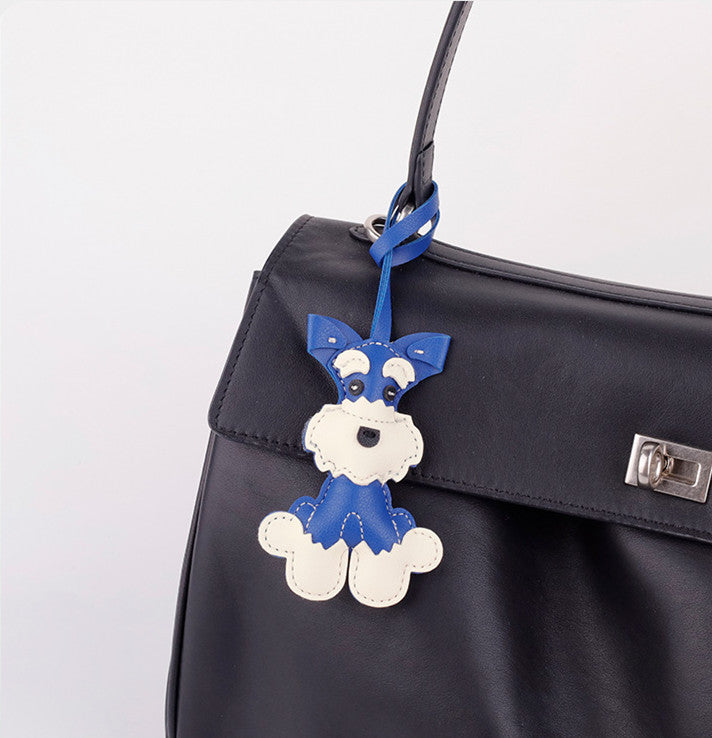 Three-dimensional dog charm clipped onto a tote