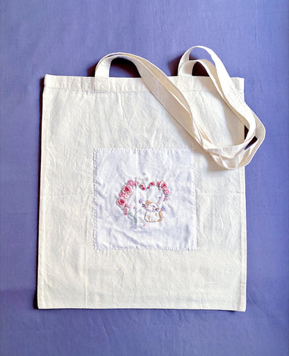 Ultra-light foldable travel tote with unique hand-embroidered art, holding essentials without weight.