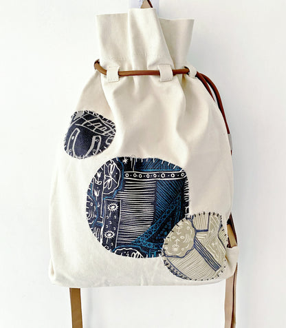 Woman strolling in park with roomy canvas backpack