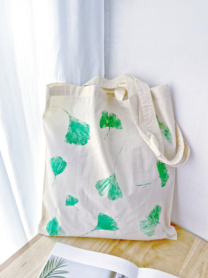 Handmade nature motif on a soft cotton bag, perfect for bohemian chic.