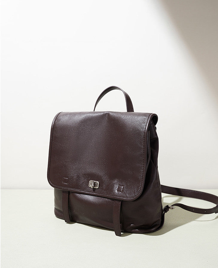 tan genuine leather backpack on wooden chair